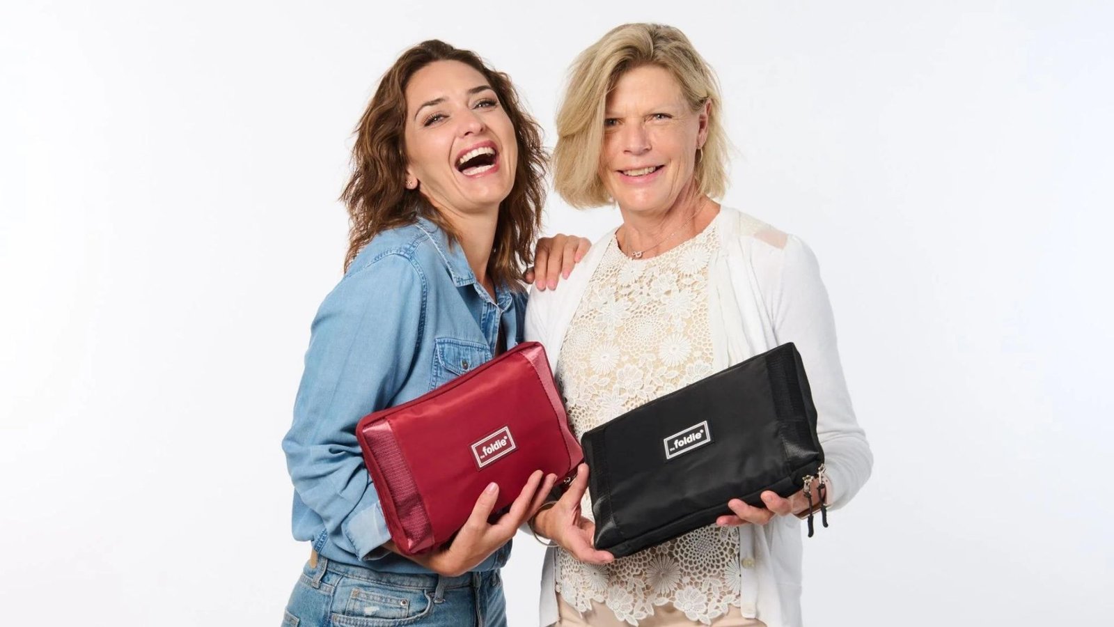 two women holding foldie travel bags 