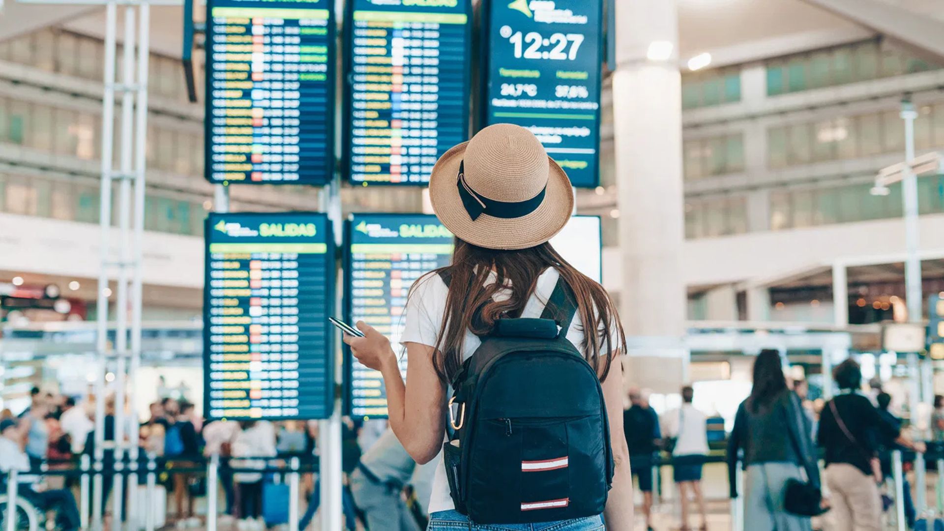 A Lady Wearing a Hat With a Black Bag On Her Back On The Best Travel Tuesday Deals 2024